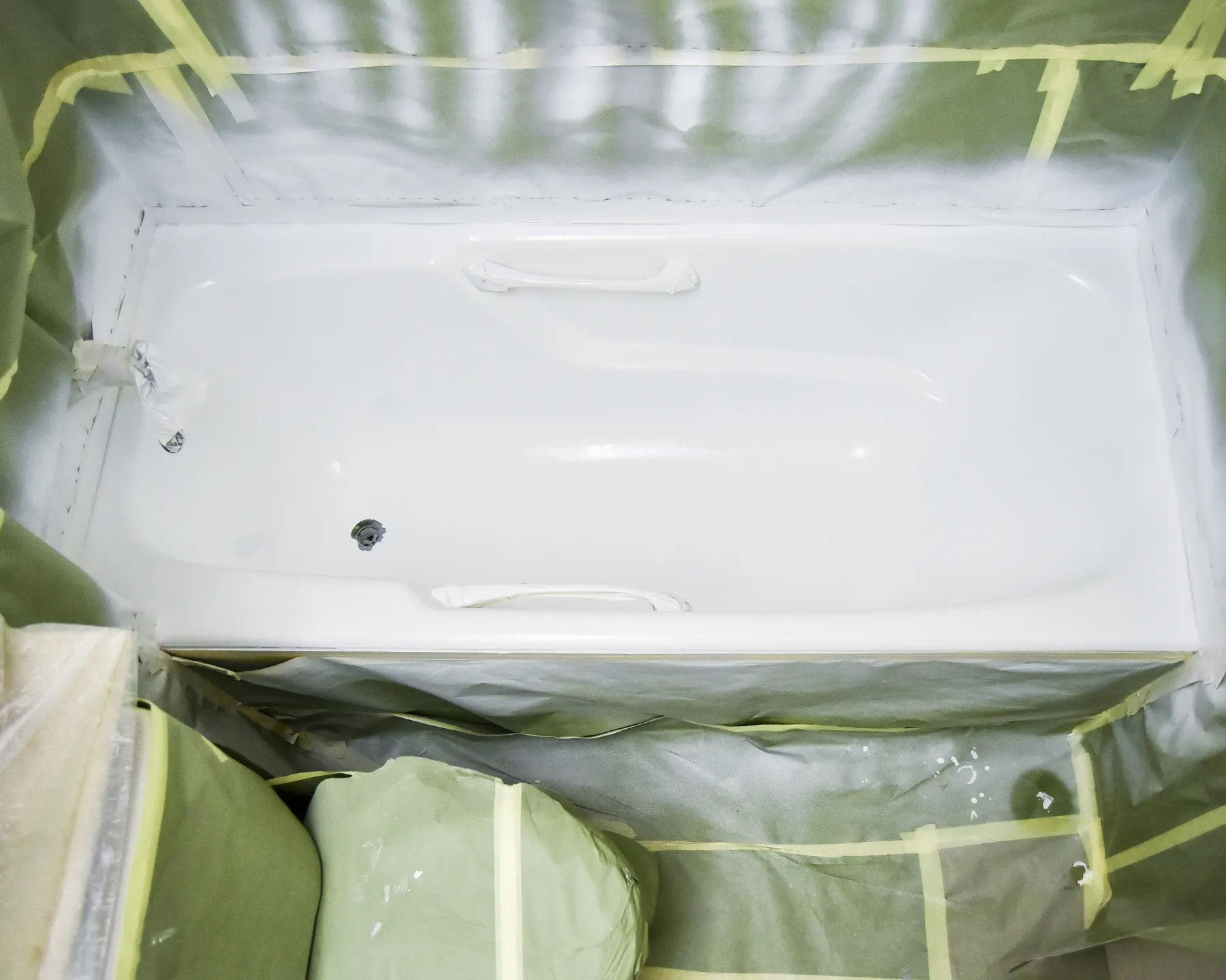 Placeholder before image showing a tub prepared for refinishing.