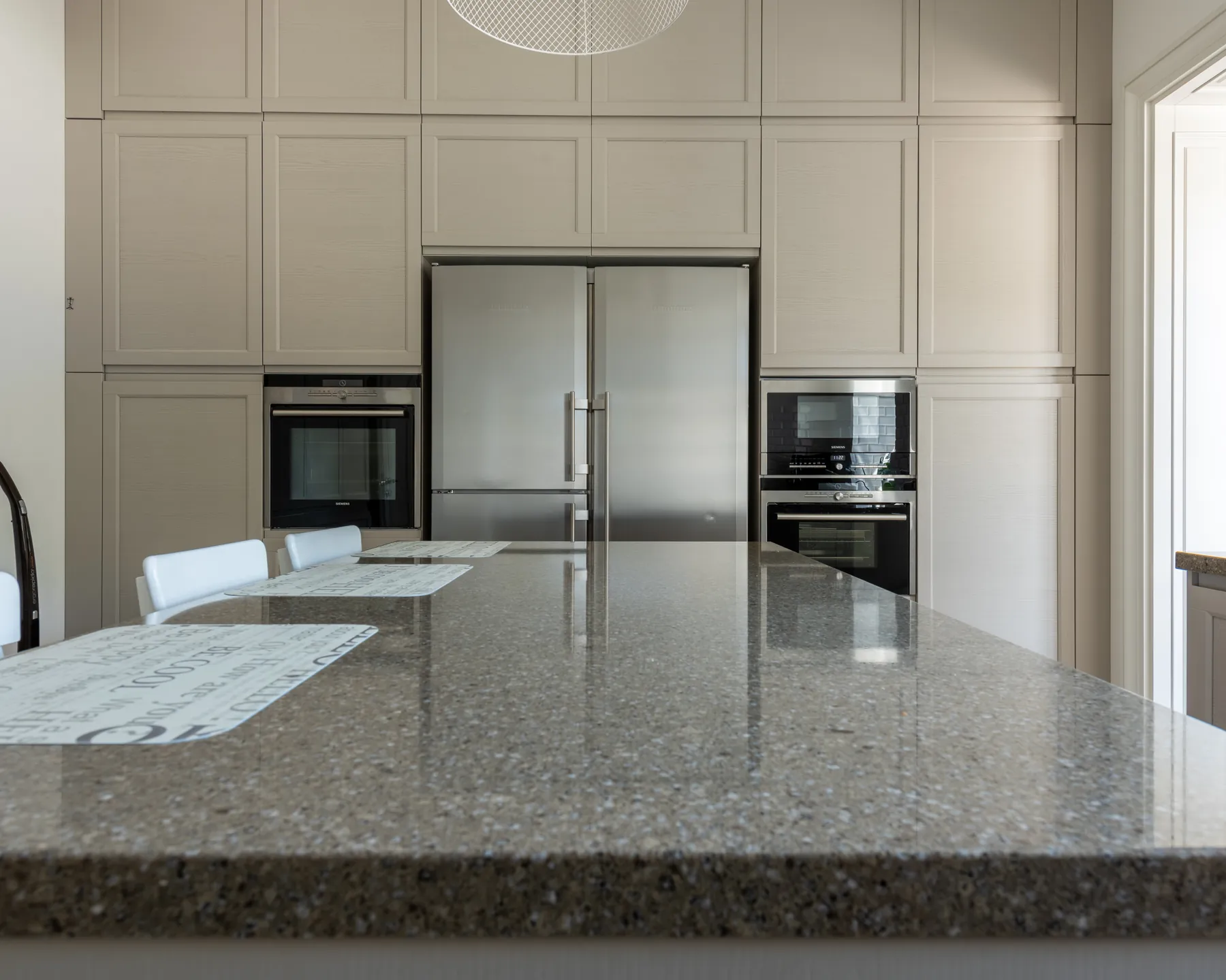 Placeholder image of a kitchen countertop surface near cabinetry and appliances.